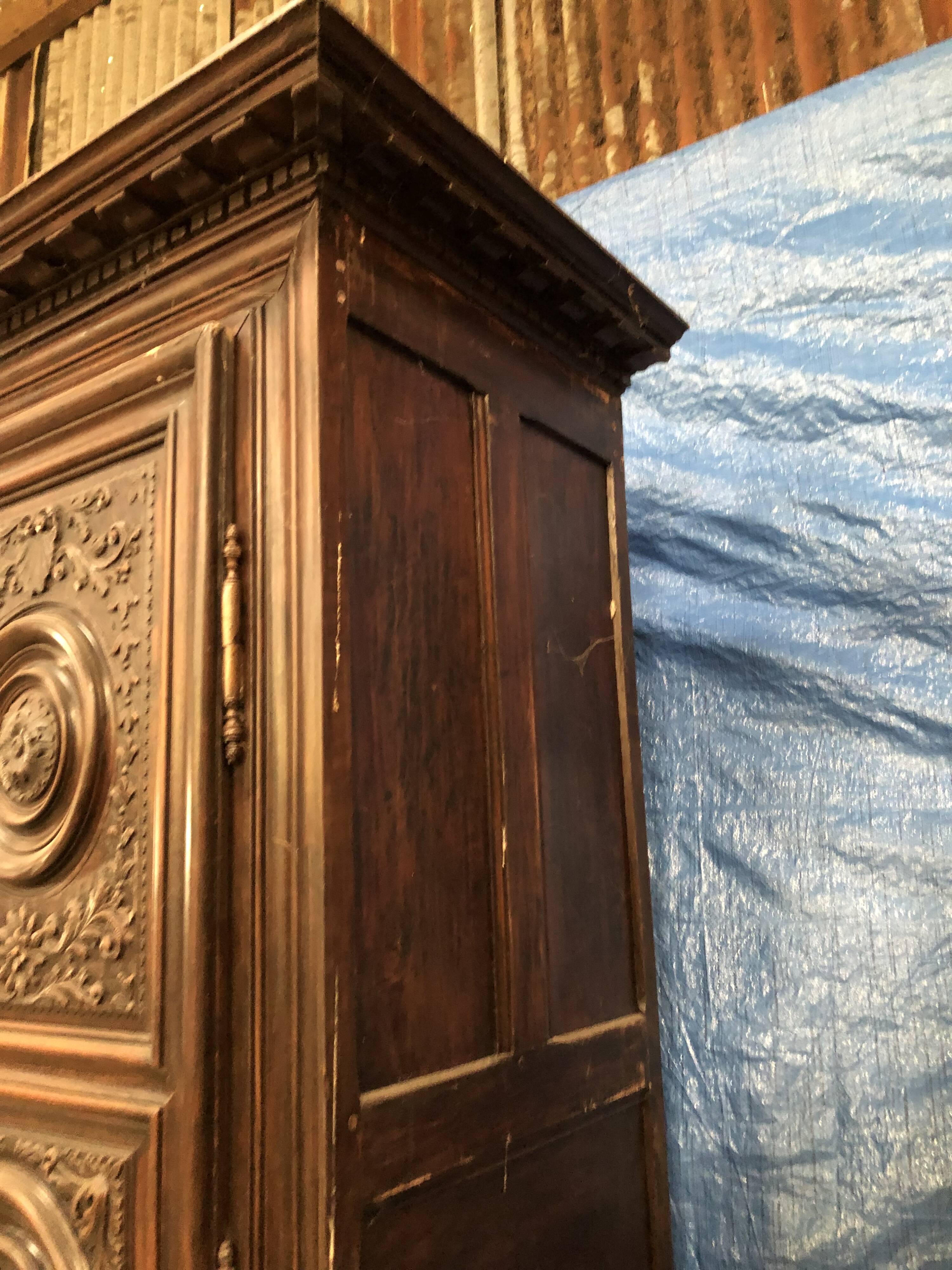 Antique Louis XIII armoire in solid walnut with carved doors