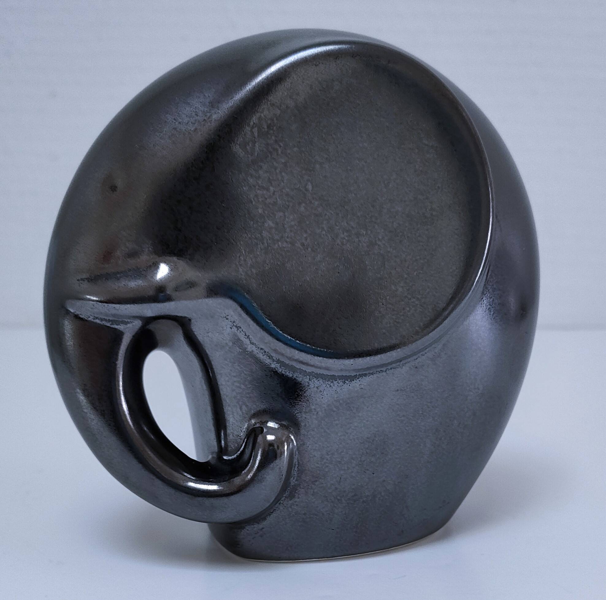 Two iridescent black and white ceramic elephants design