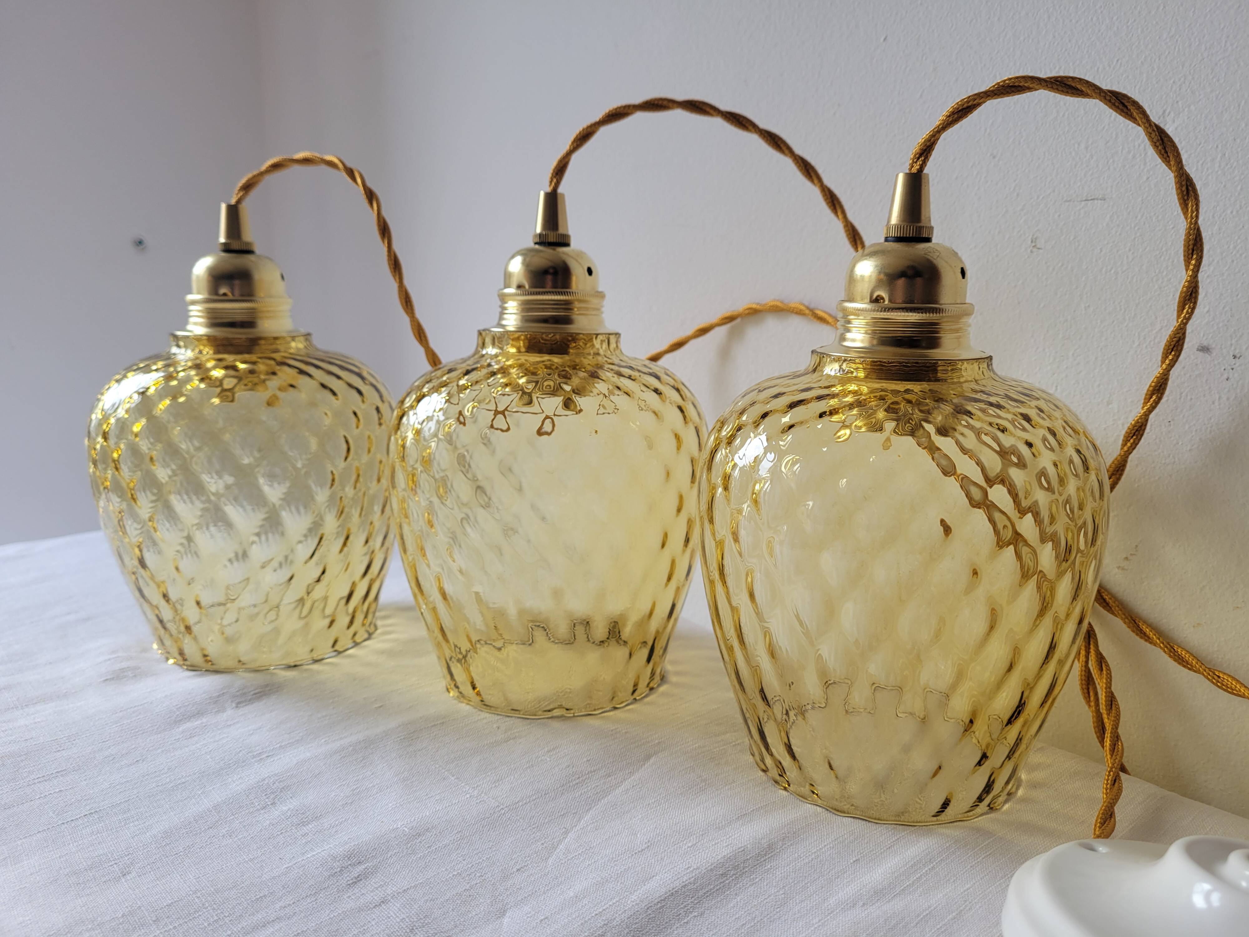 Trio of yellow glass pendant lights
