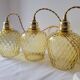 Trio of yellow glass pendant lights