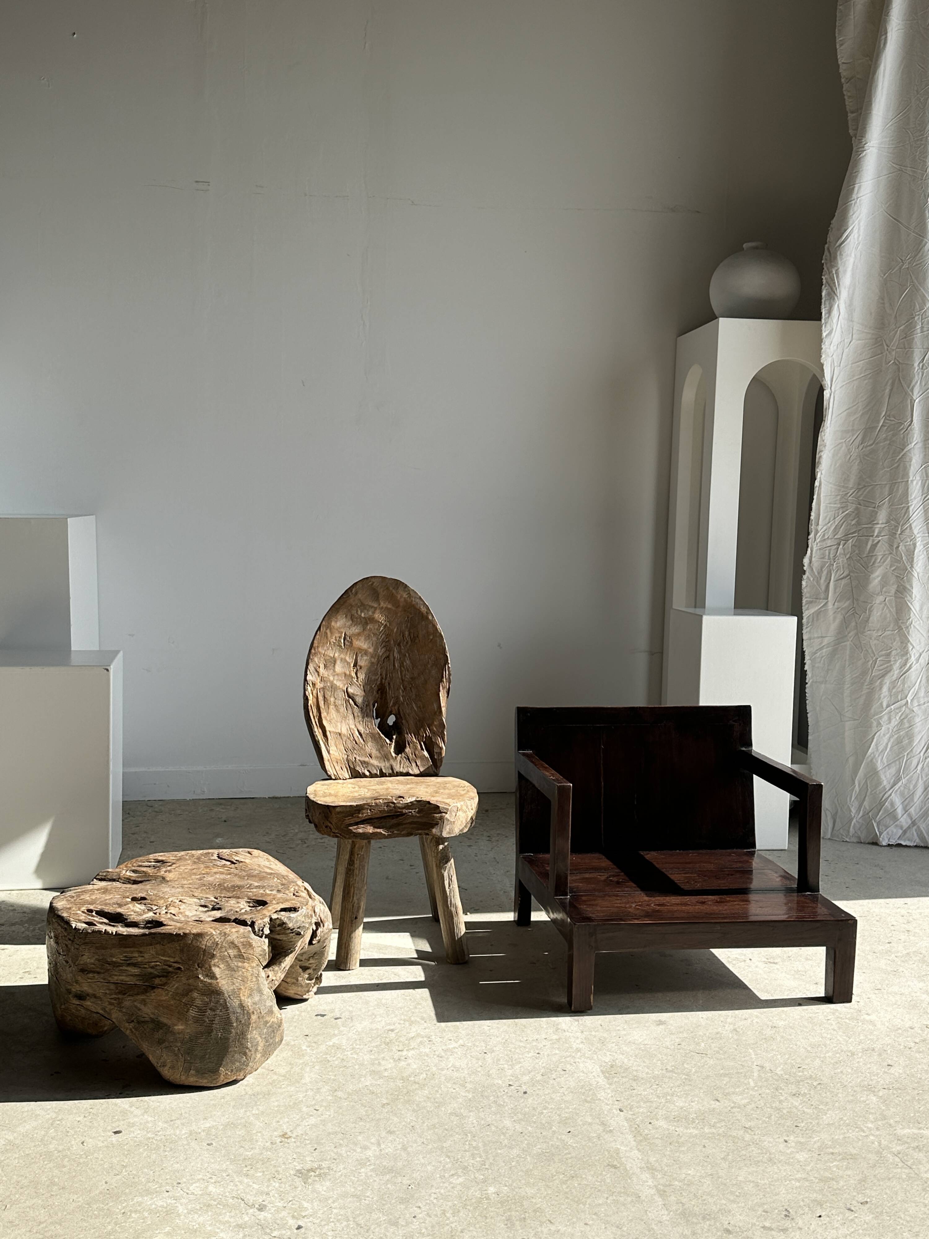 Small low armchair in varnished brown wood