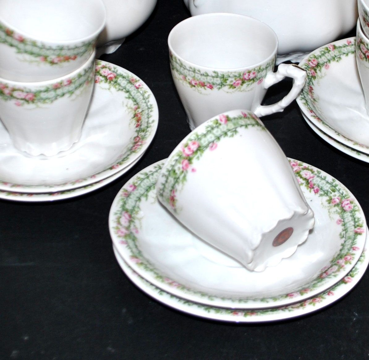 Vintage Limoges coffee service with pink and green floral decoration, coffee pot, sugar bowl, and 6 cups.