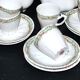 Vintage Limoges coffee service with pink and green floral decoration, coffee pot, sugar bowl, and 6 cups.