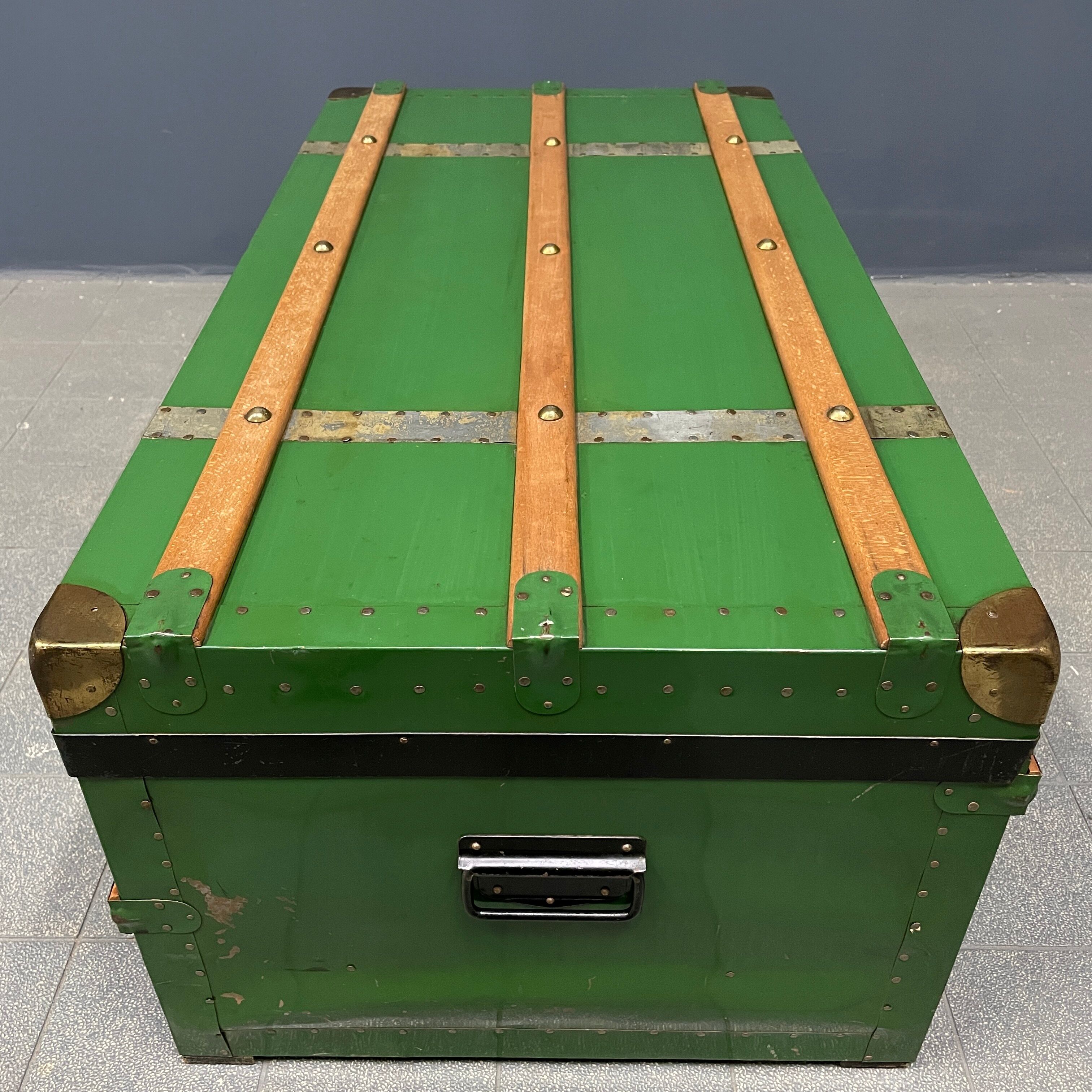 Green metal trunk with wooden sleds