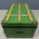 Green metal trunk with wooden sleds