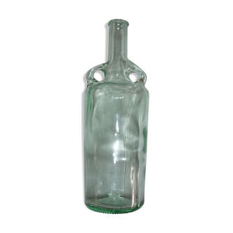 Old transparent moulded glass bottle