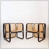 Pair of designer armchairs in curved wood and wicker