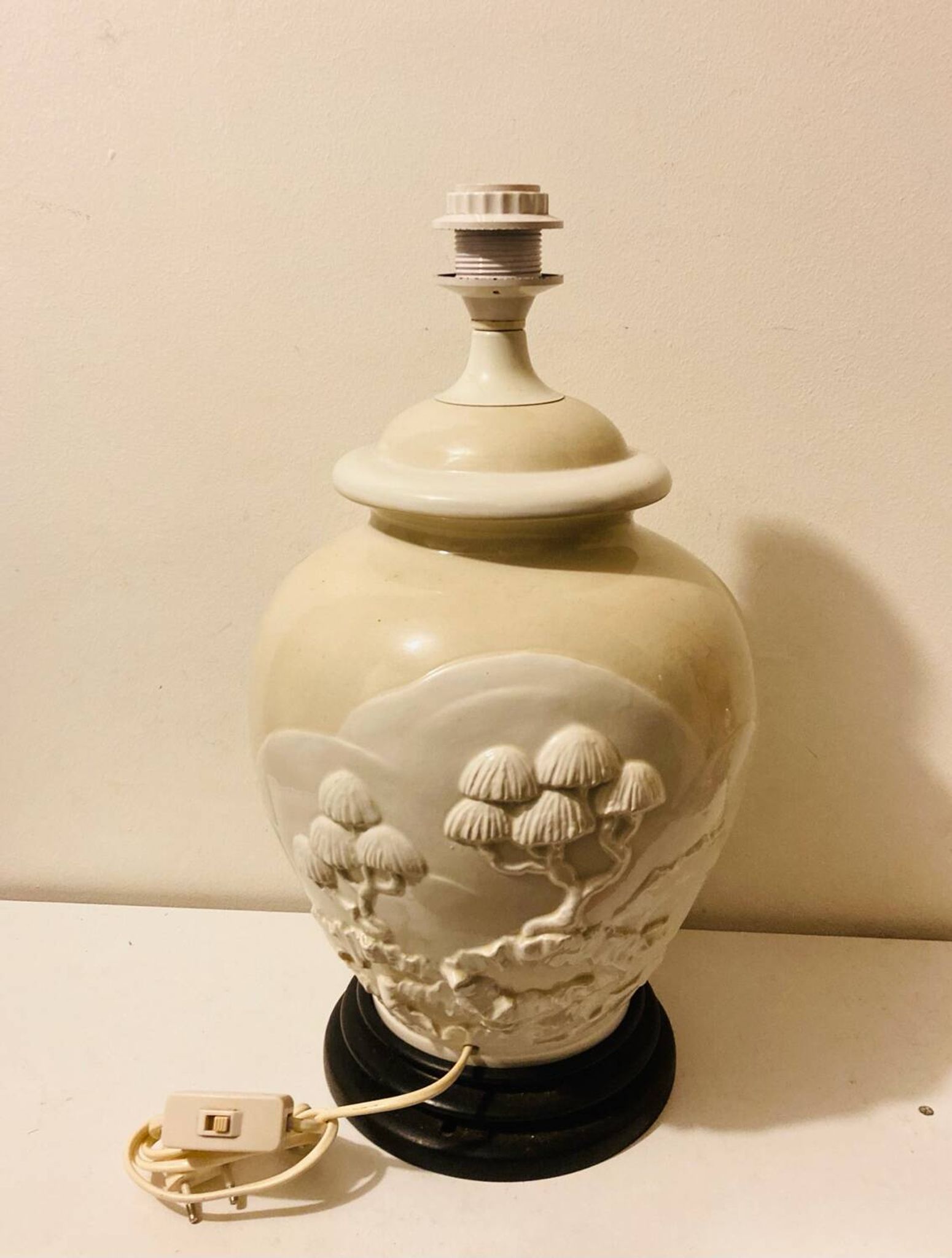 1980s ceramic table lamp with a wooden base and adjustable shade.