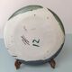 Glazed ceramic plate representation man between two lands unknown signature