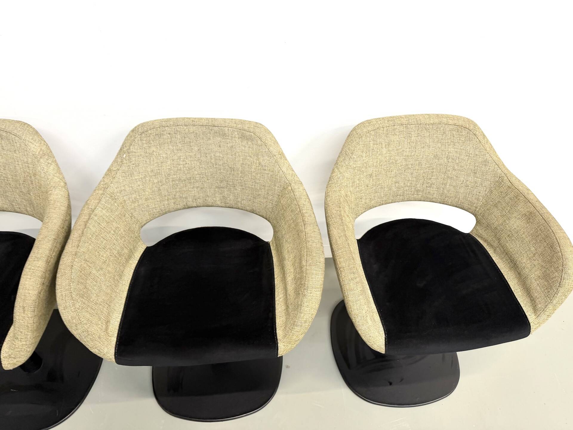 Series of six swivel chairs with an organic shell, patterned fabric and base.