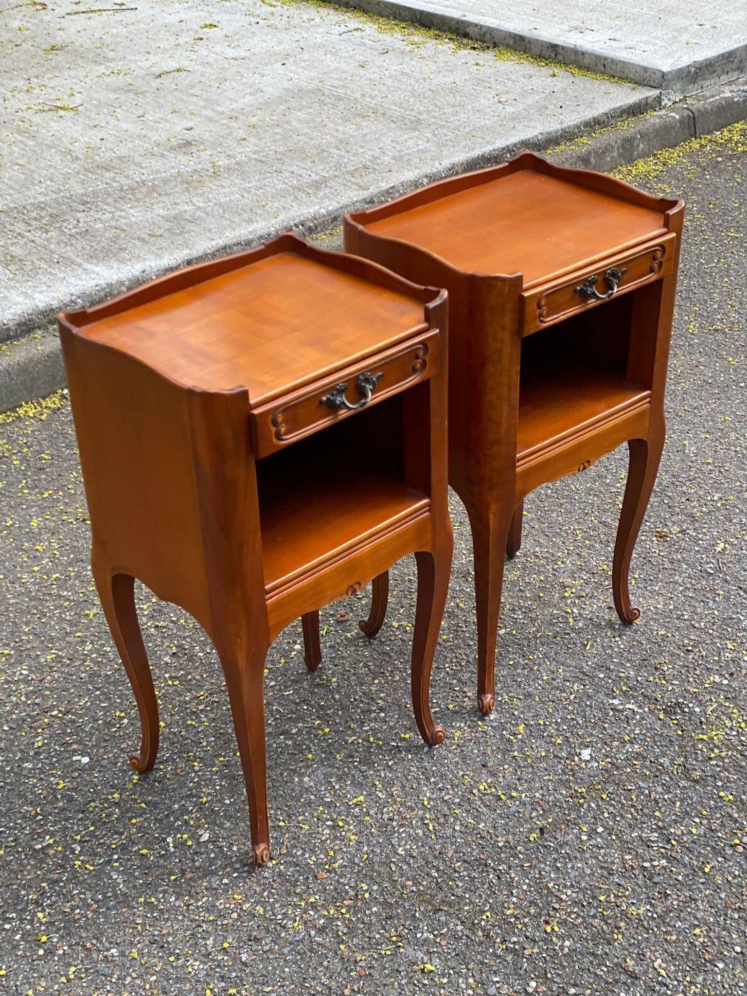 2 Louis XV bedside tables made of curved solid wood with drawers.