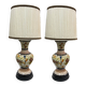 A pair of lamps with a pleated couture lampshade in wild silk