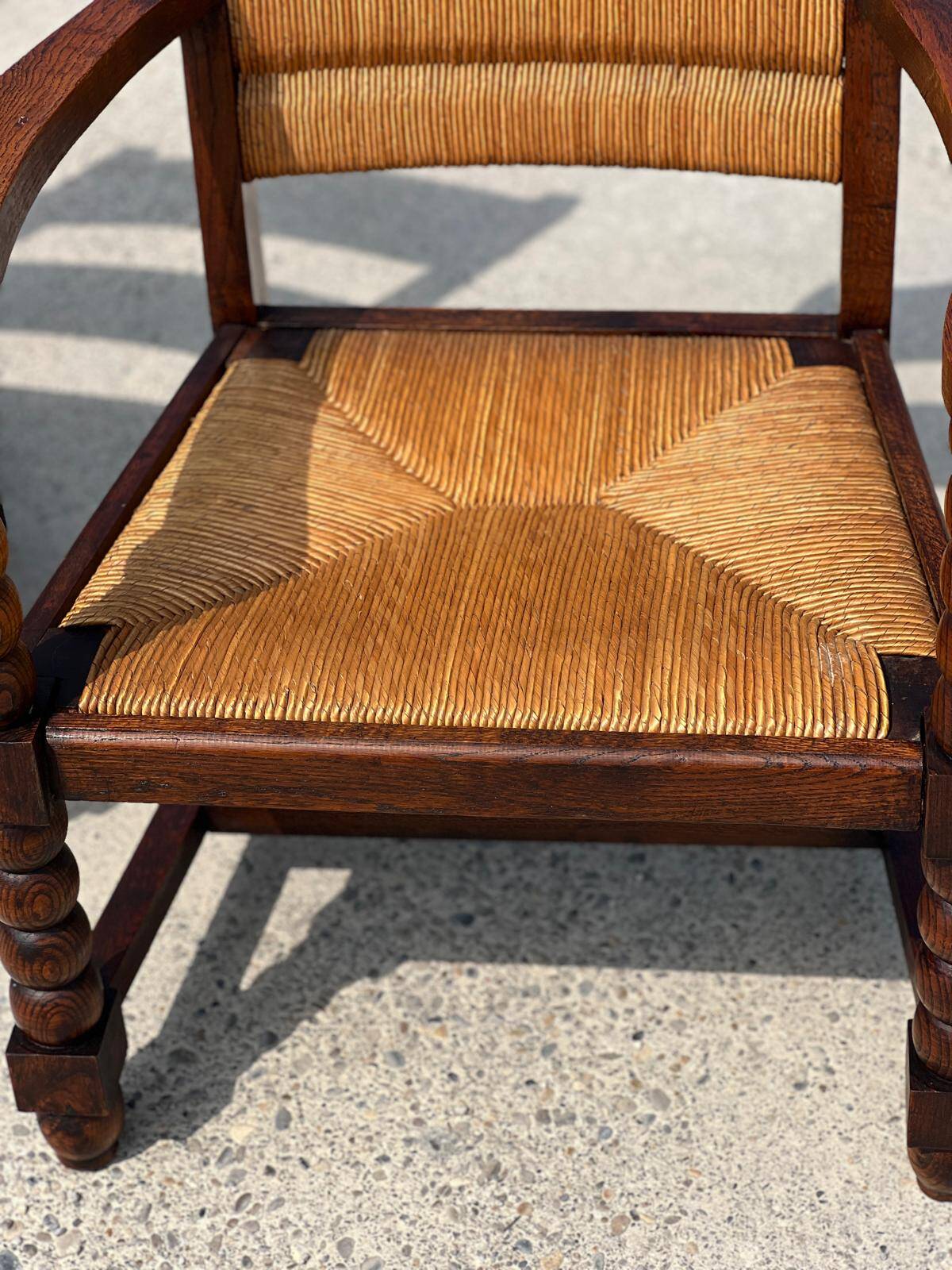 Pair of stained oak and straw armchairs, French work, 1950