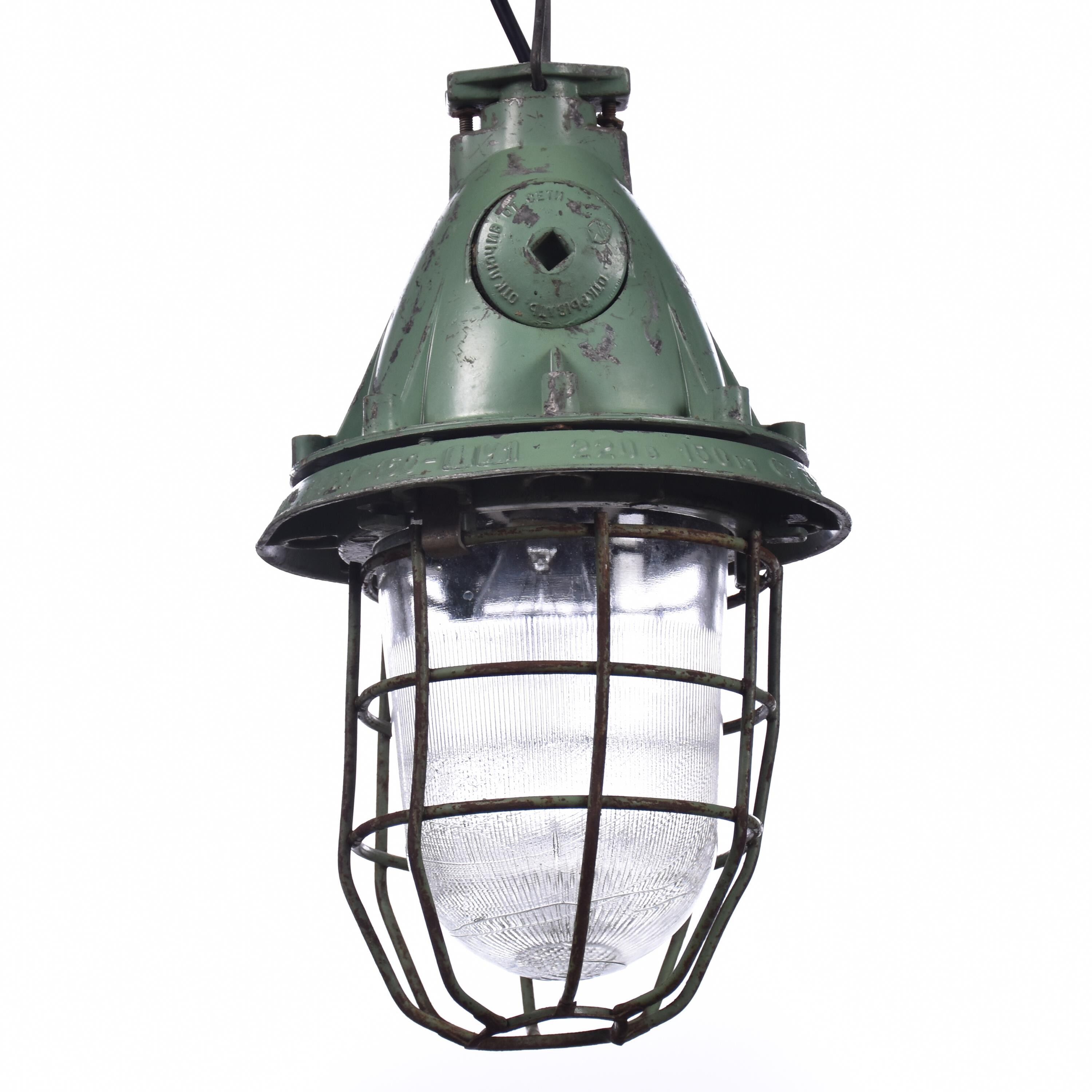 Industrial caged green lamp