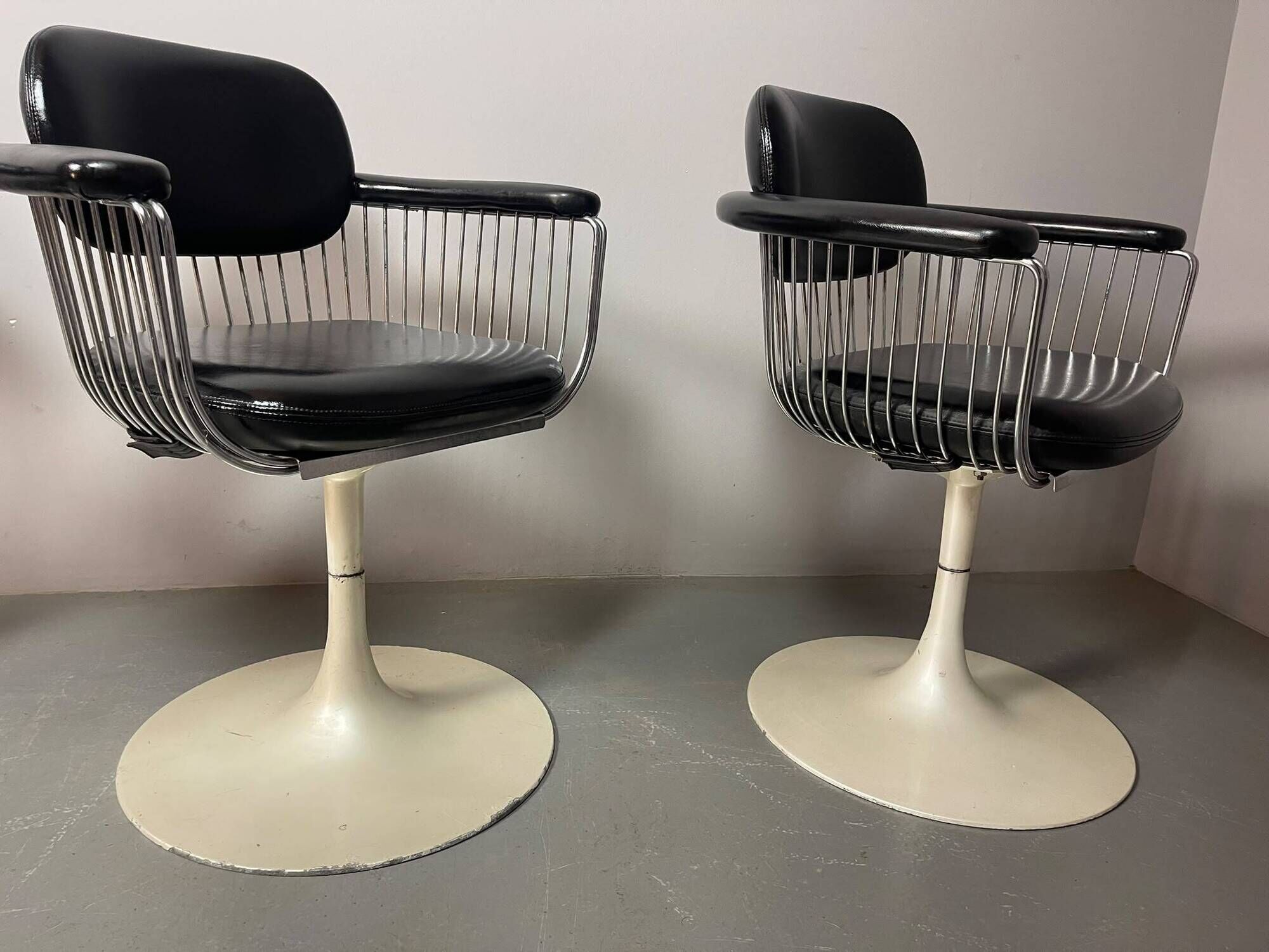 A striking set of four vintage swivel dining chairs