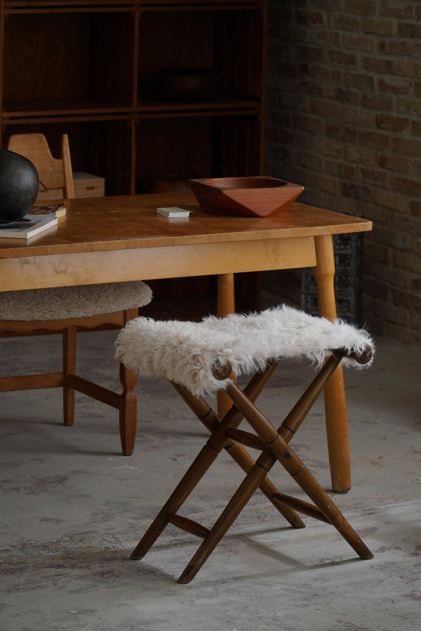 Folding stool, reupholstered in long-haired sheepskin, mid-century modern style, 1950s.