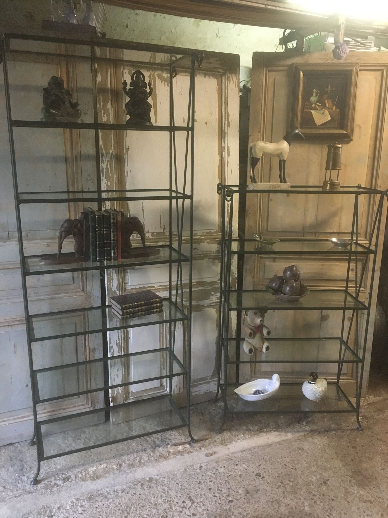 Pair of wrought iron and glass bookshelf shelves.