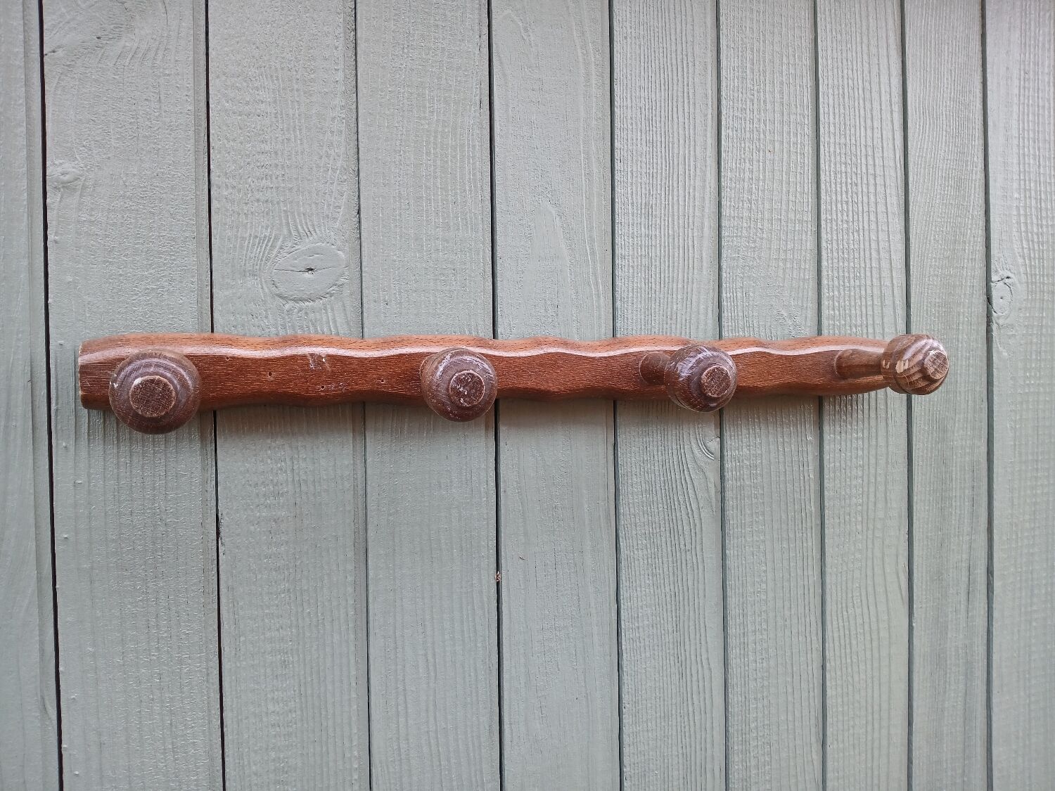 Small antique wooden wall coat rack.