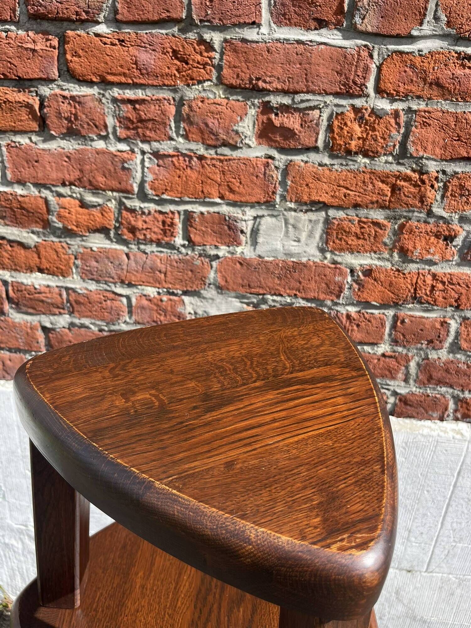 Nested tripod tables made of solid wood, in a modernist brutalist style.