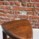 Nested tripod tables made of solid wood, in a modernist brutalist style.