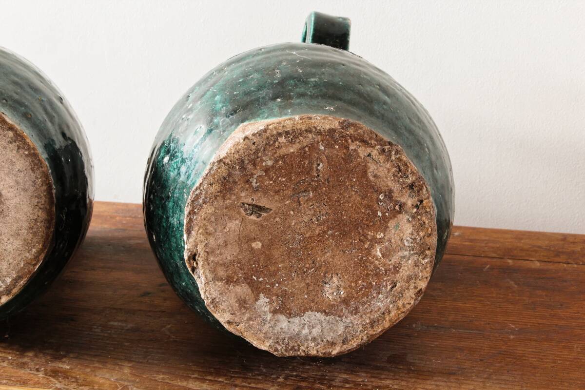 Set of two Chinese green glazed stoneware storage jars.