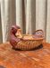 Wicker basket in the shape of a duck.
