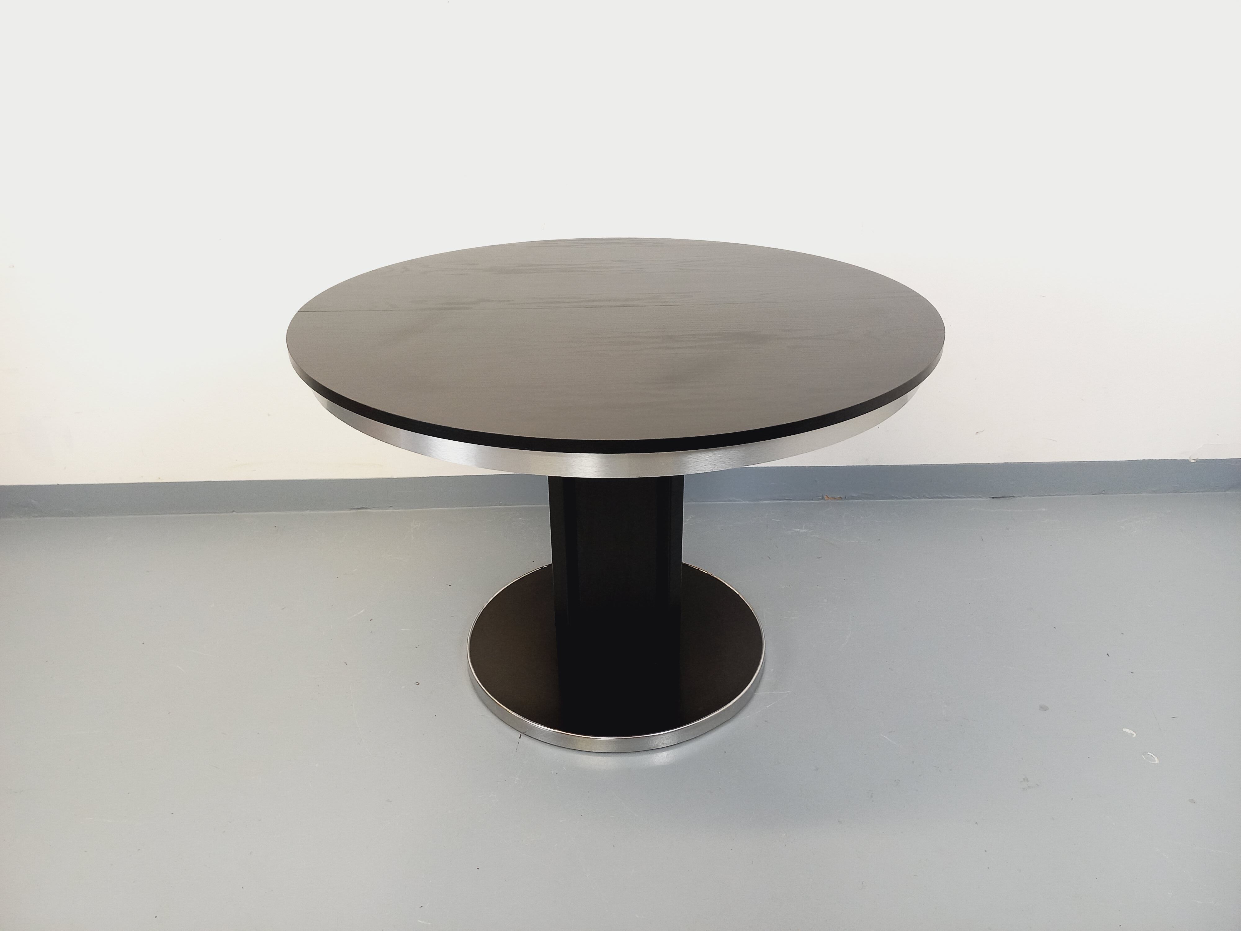 Vintage dining table in melamine with a black wood effect and chrome metal.