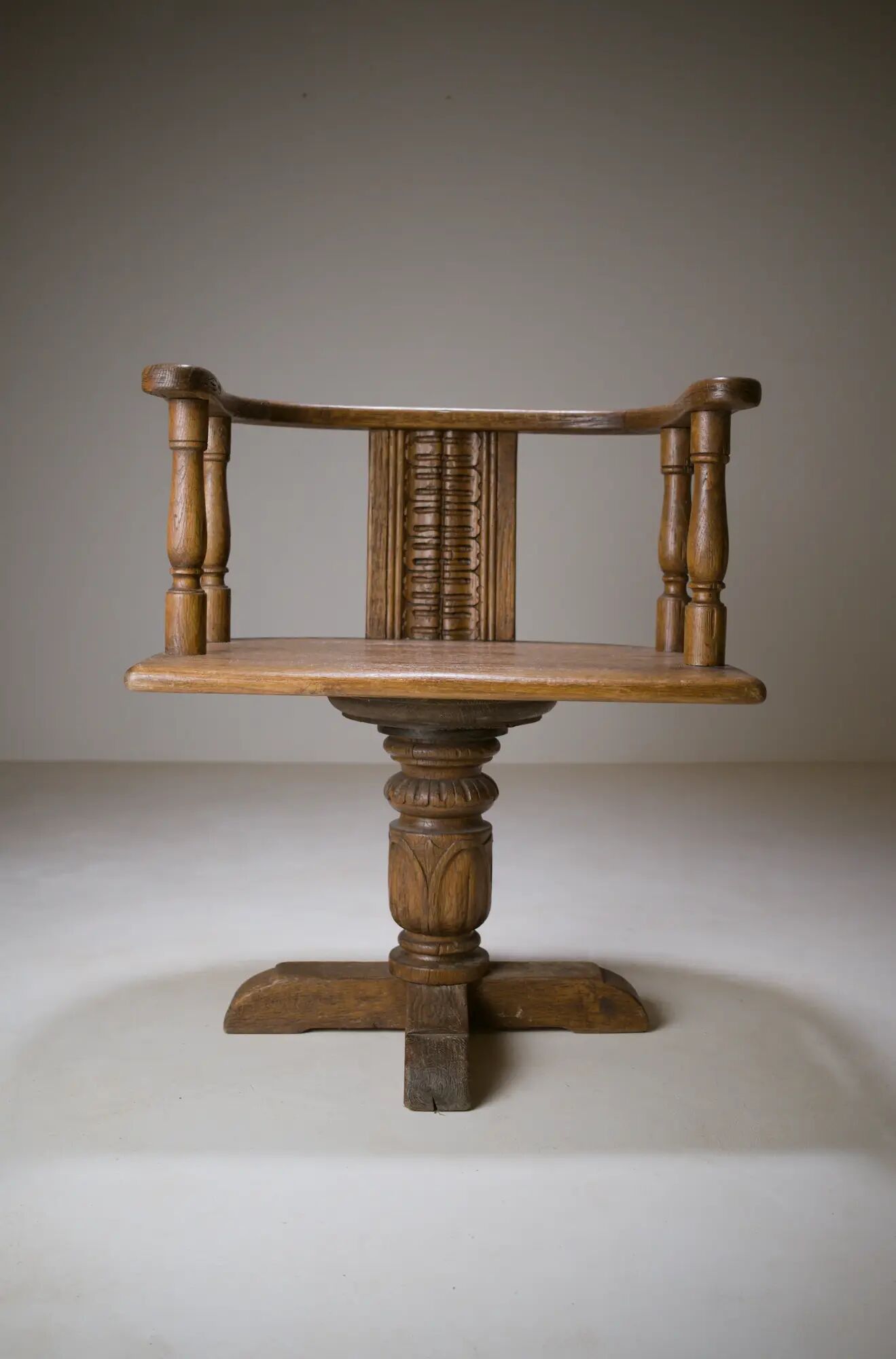 Swivel armchair in carved oak with ball bearings, early 20th century.