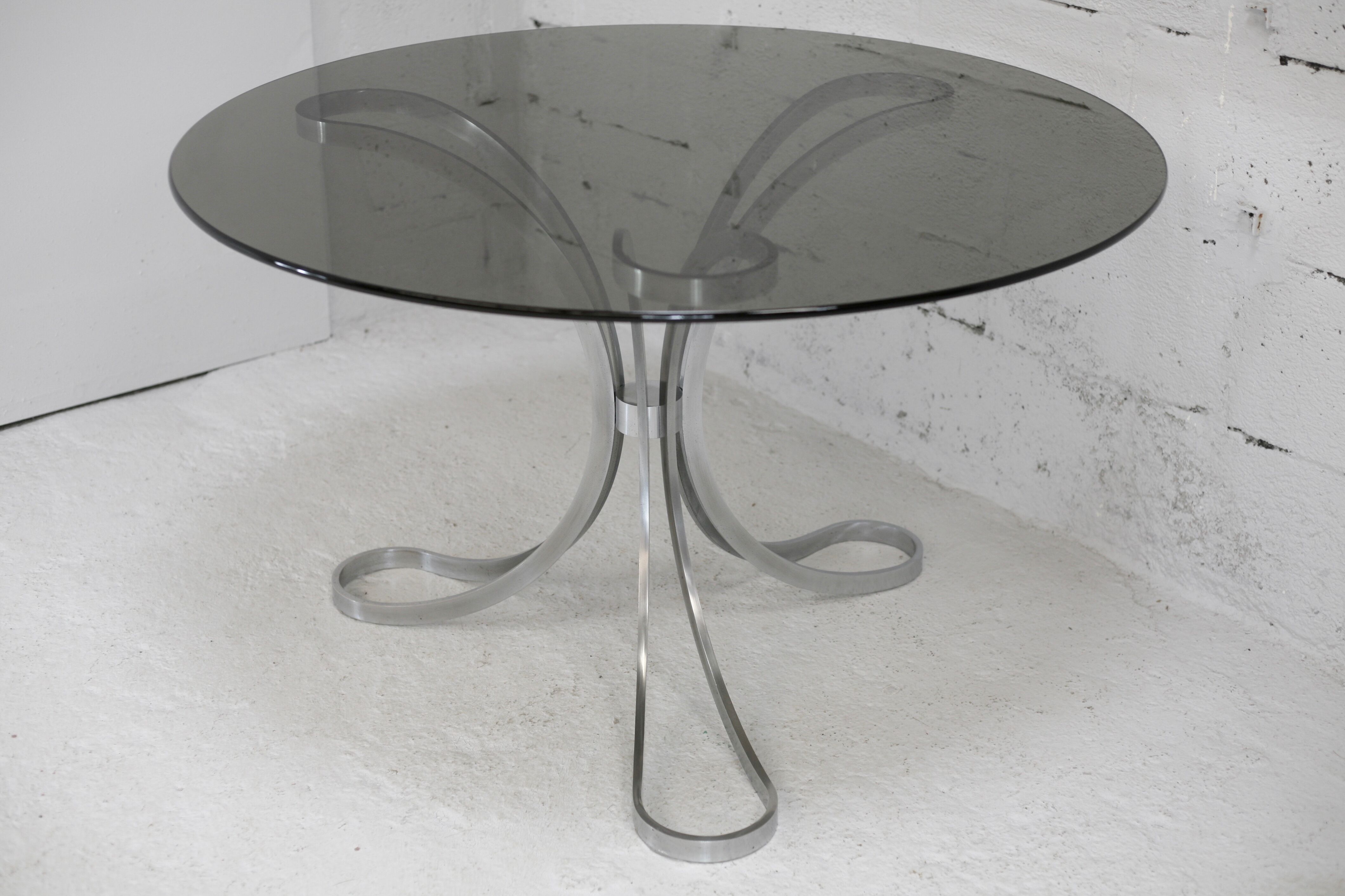 Living room table "Space Age" polished steel, circular slab smoked glass. France, circa 1970.