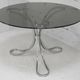 Table de séjour "Space Age" acier poli, dalle circulaire verre fumé. France, circa 1970.