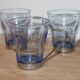 Set of 5 vintage blue-tinted glass cups with metal holders.