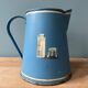 Old painted sheet metal jug or milk jug