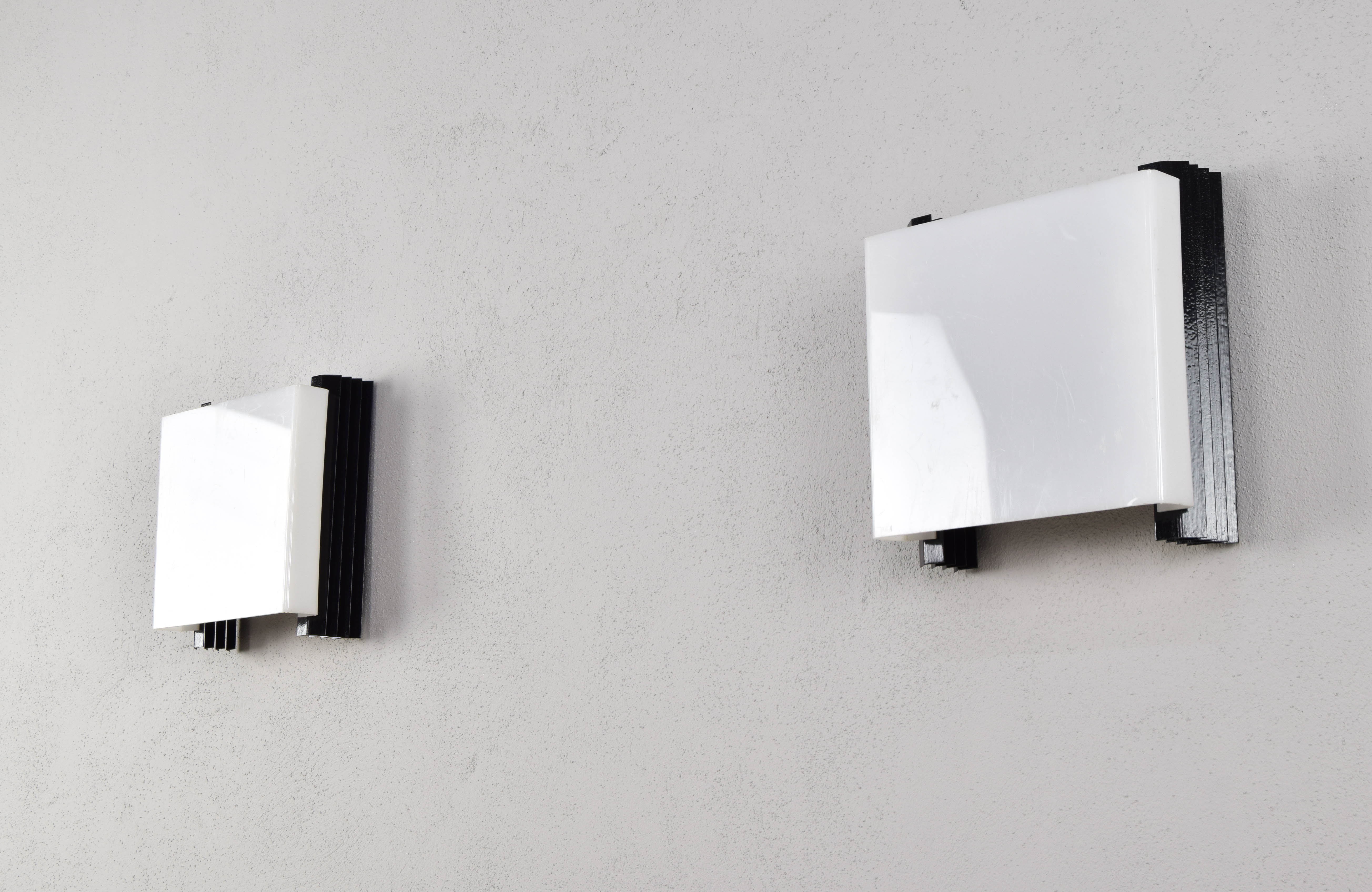 Mid-century modern sconces of black iron sheets and white lucite spain 1960s