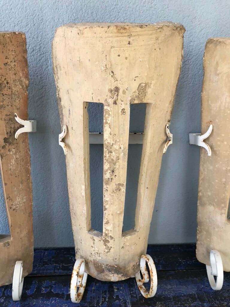 Lot of three terracotta and wrought iron appliques