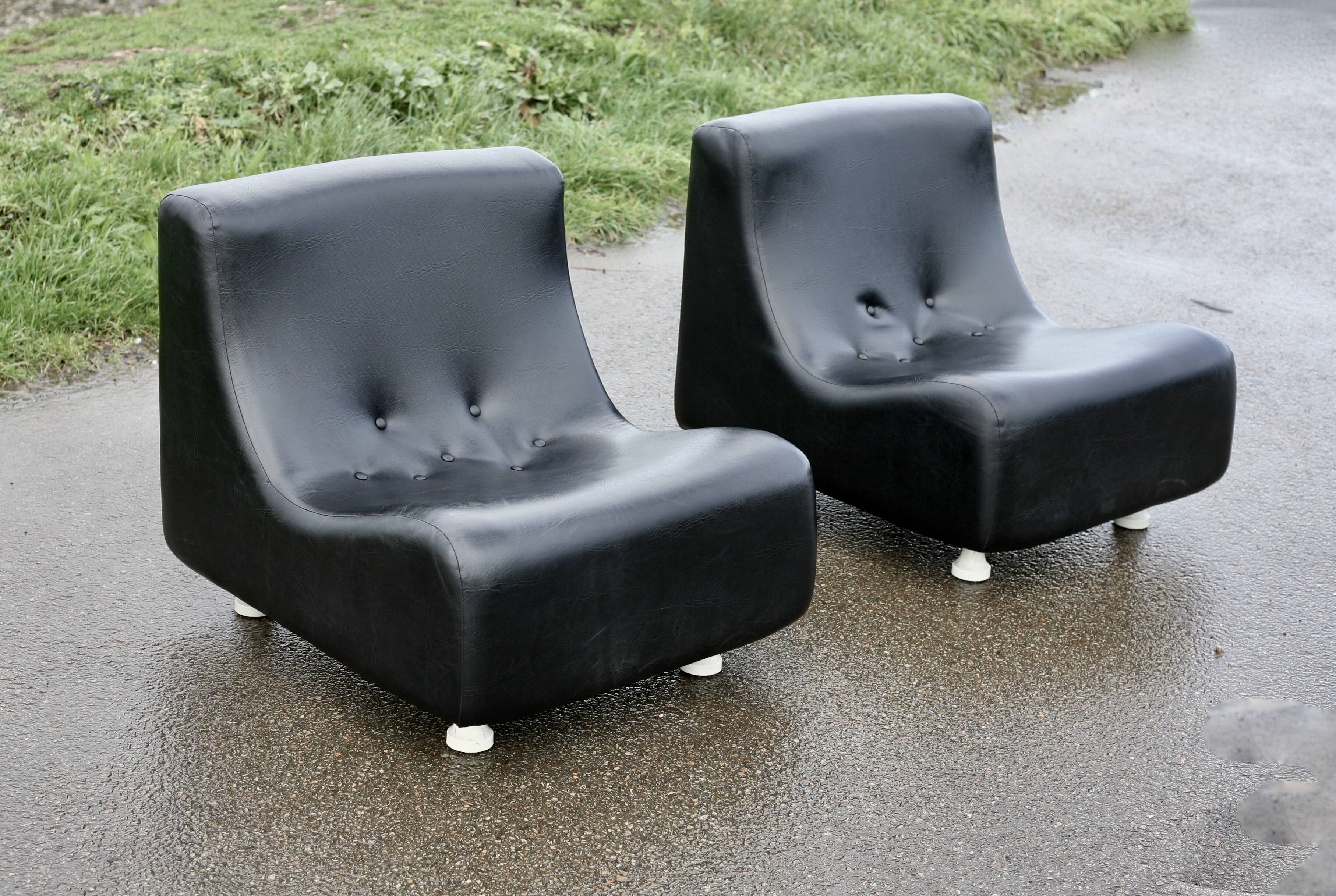 Pair of “space age” low chairs. Black faux leather. Circa 1970