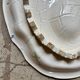 Oval Moustiers plate in cream and green earthenware, 18th century.