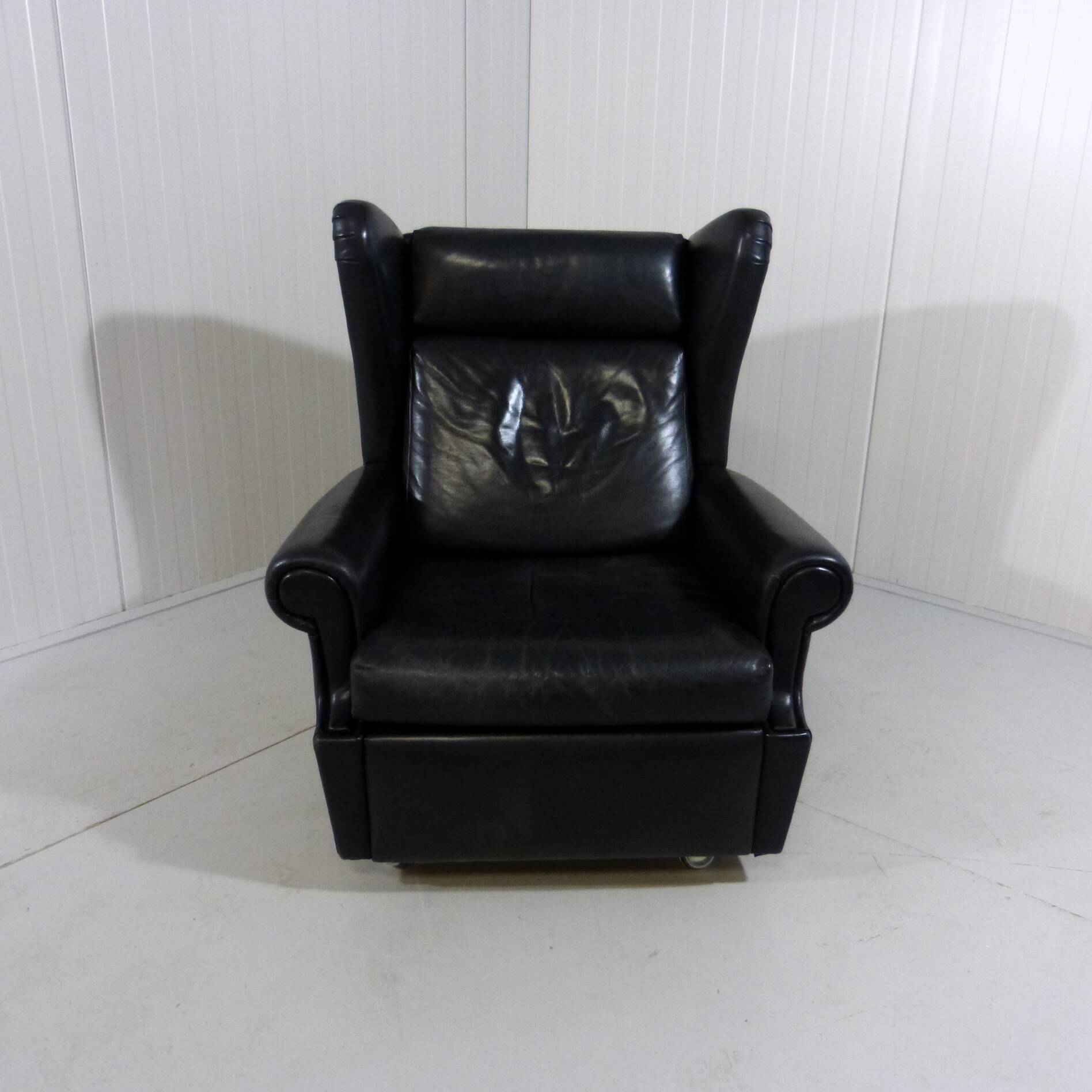 Black leather wingback chair on wheels 1960’s