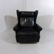 Fauteuil à oreilles en cuir noir sur roulettes années 1960