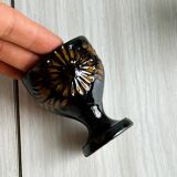 3 black ceramic egg cups with floral patterns