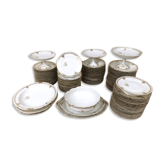 Encrypted service in Limoges porcelain with gold décor, 112 pieces