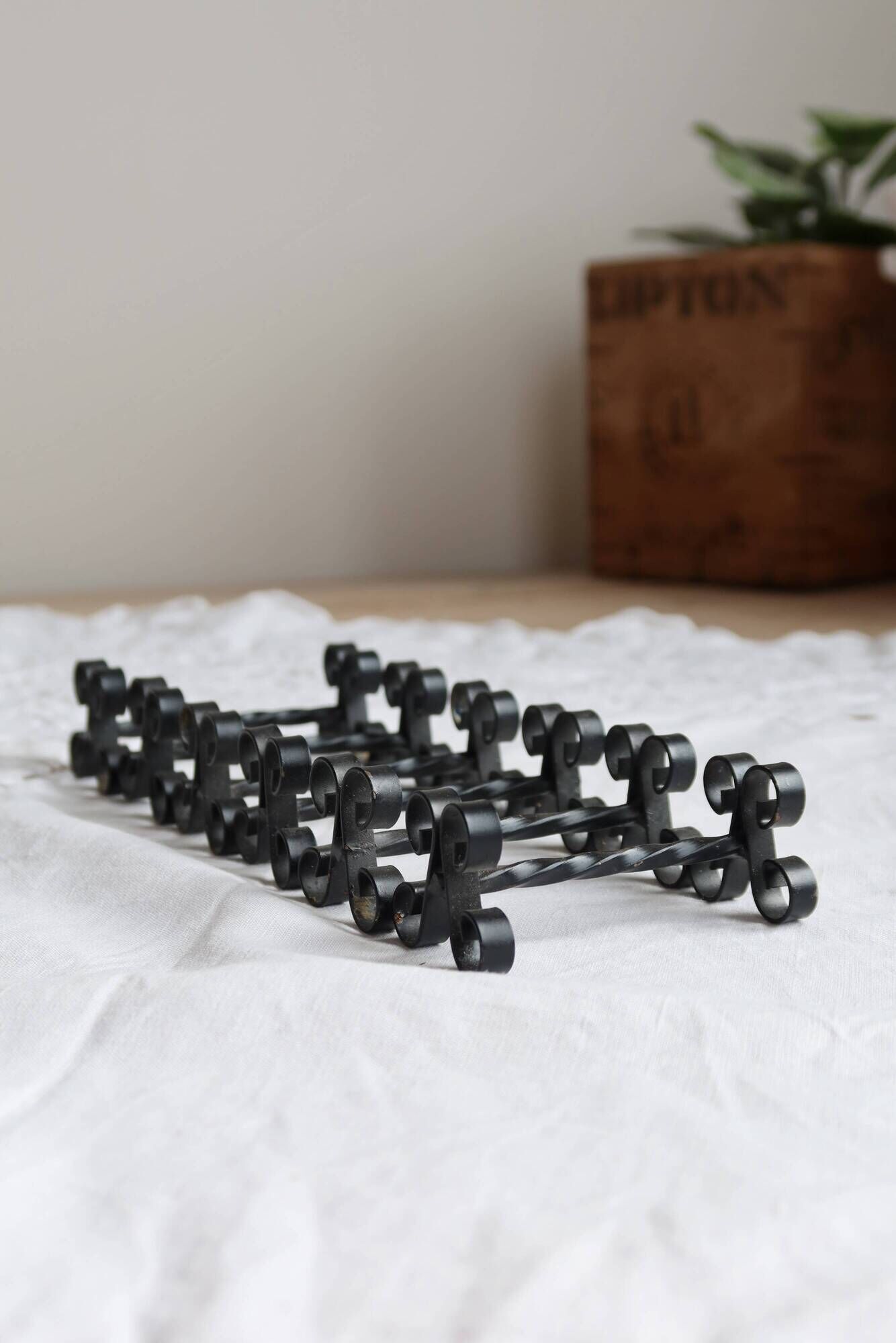 6 vintage black metal knife rests with scroll decorations