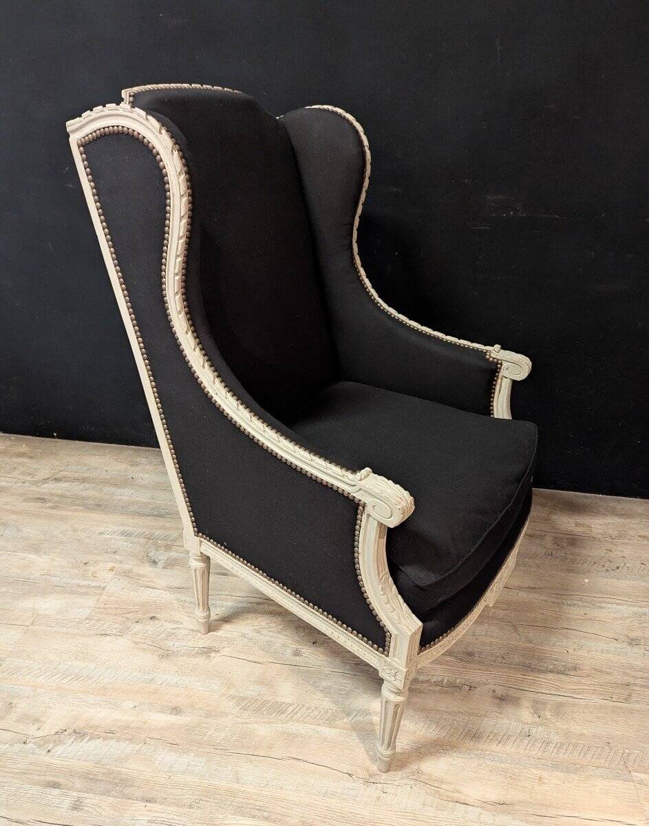 Pair of Louis XVI armchairs with ears in grey painted wood and black fabric.