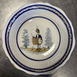 Large earthenware centerpiece dish with painted decoration of a drummer