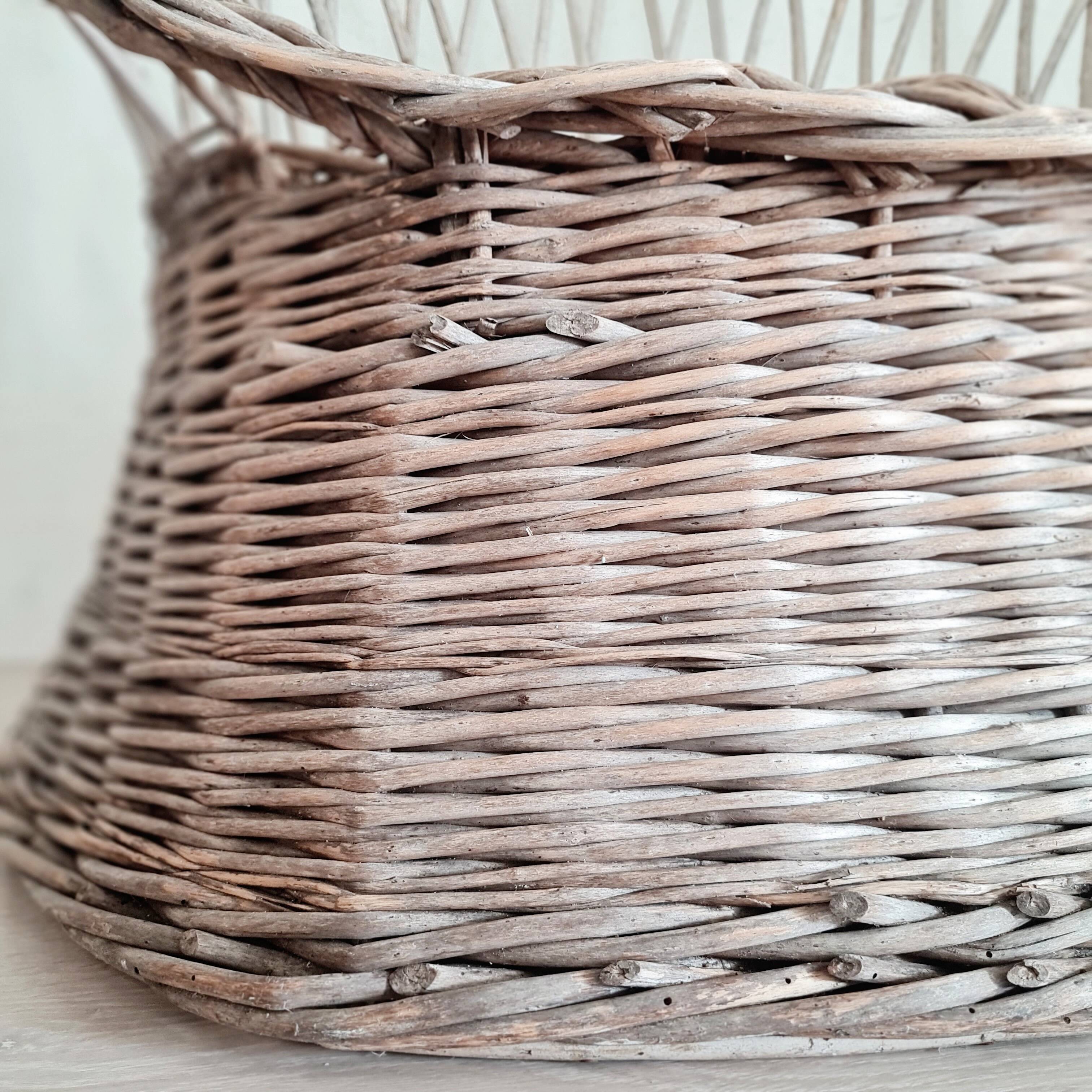 Antique armchair in gray woven wicker
