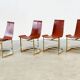 Set of four leather and brass Italian dining chairs