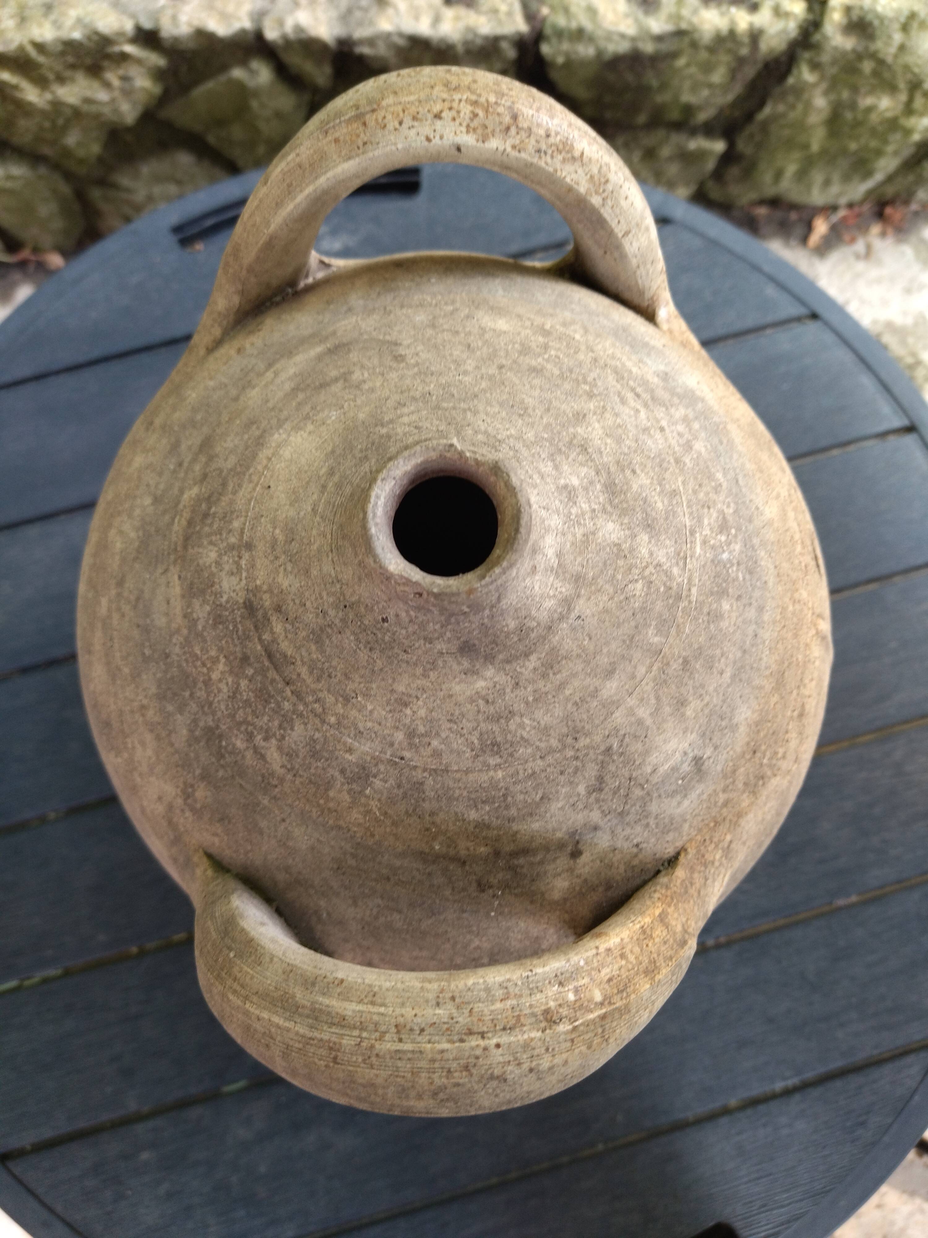 Ancient sandstone jar with two handles