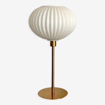 Table lamp with an antique white opaline lampshade and a vintage golden foot