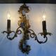 Pair of Italian Hollywood Regency wall lights in iron and gilded sheet metal.