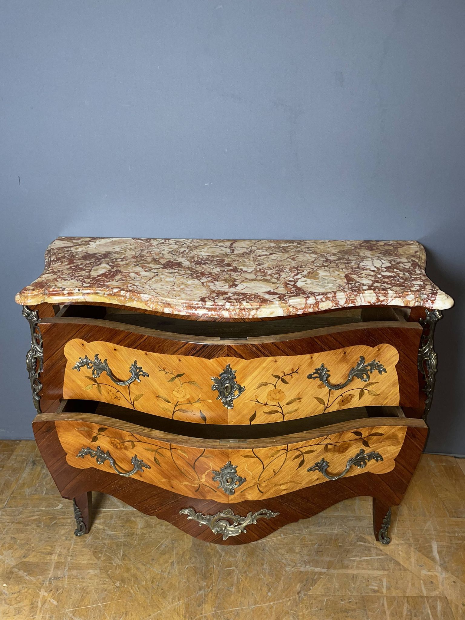 Louis XV style commode with floral marquetry decoration.