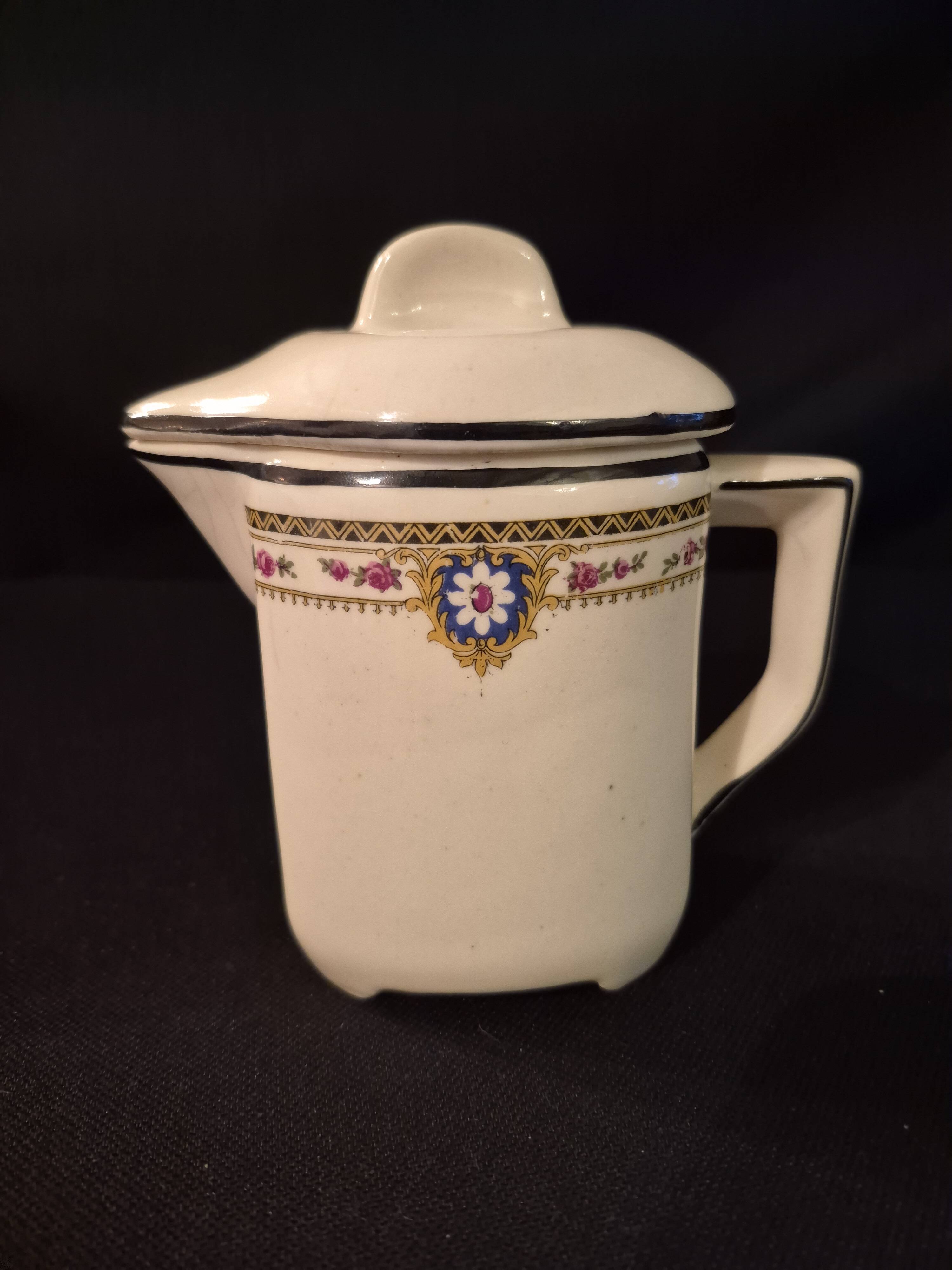 Old covered jug, vintage, geometric frieze and flowers with a border.